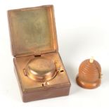 A travelling inkwell and a vegetable ivory tape measure.