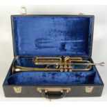 A B & M Champion brass trumpet in a fitted, blue velvet lined case, length of trumpet 55cm.