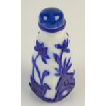A tall tapering square section carved blue and white Peking glass snuff bottle, height 10.5cm.