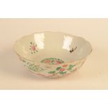 A Chinese petal rimmed bowl decorated in the famille rose palette,