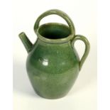 A Dunmore green glazed pottery ewer, height 20cm, width 15cm.