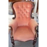 A Victorian mahogany gentleman's armchair, with a button upholstered back,