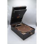 An H.M.V. black portable gramophone height 14cm, width 28.5cm, depth 41.5cm.