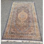 A Persian carpet, the indigo field with a central medallion and the Herati pattern,
