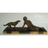 An Art Deco black marble and slate figure of a spelter lady and dog, height 26cm, length 67cm,