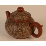 A Chinese Yixing teapot, of mottled design, seal mark and other marks, height 9.5cm, width 15cm.