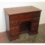 A George III mahogany secretaire kneehole desk,