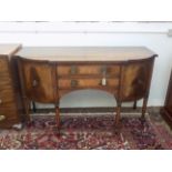 A George III style mahogany sideboard, with two central drawers flanked by a pair of cupboard doors,