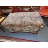 A Victorian mahogany framed tapering ottoman upholstered in floral velvet, width 101cm.