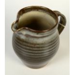 A Leach pottery jug, with a ribbed body, height 15.5cm.