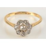 A diamond flowerhead cluster ring in 18ct gold, size M.