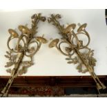 A pair of gilt metal wall lights, early 20th century, each with three branches, height 91cm.