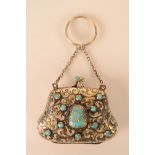 A silver gilt small purse set with a turquoise panel with gilt Arabic description,