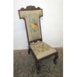 A Victorian mahogany prie dieu chair, with a floral decorated needlepoint back and drop in seat,