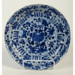 A Chinese blue and white Kangxi style dish with fluted sides,