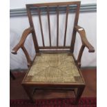 A George III walnut rush seated open armchair,