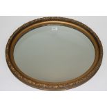 An oval gilt framed wall mirror, 55 x 67cm.