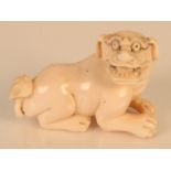 An ivory netsuke carved as a dog of fo, height 2.7cm, length 4.5cm.
