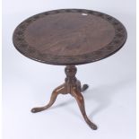 A George III mahogany tripod table, the circular tilt top, with rosette carved border,