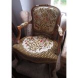 A French walnut open armchair, with padded back and seat on floral carved cabriole legs,