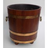 A mahogany and brass bound, twin handled peat bucket, 20th century, with bun feet, height 44cm,