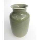 A Chinese celadon vase, decorated with flowers and leaves, height 20cm.