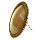 A brass framed convex photo frame, early 20th century, height 15.5cm, width 12cm.