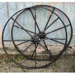 A pair of black painted iron implement wheels, each with eight spokes, diameter 122.5cm.