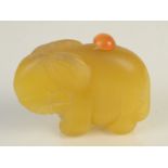 An elephant carved yellow stone snuff bottle, height 4.9cm, width 6.2cm.