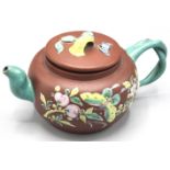 A Chinese Yixing teapot, enamelled to the exterior with a butterfly amongst foliage,