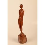 A carved fruitwood figure of a lady standing on a tree trunk, height 53cm.