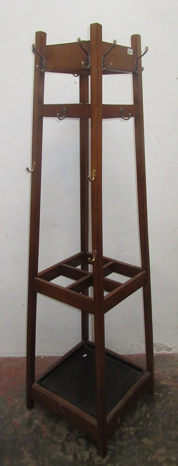 An Arts and Crafts oak hallstand, of square form with four sections for walking sticks etc.