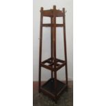 An Arts and Crafts oak hallstand, of square form with four sections for walking sticks etc.