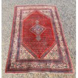 A Seraband rug, north west Persia, the madder field with a central medallion and rows of boteh,