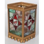A gilt metal and stained glass hanging lantern, early 20th century, each panel lead lined,