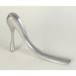 A Manolo Blahnik aluminium shoe horn, height 19cm, length 28cm.