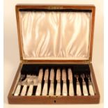 A set of six dessert knives and forks with mother of pearl handles cased.