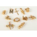 A collection of eleven gold charms, 28.6g.