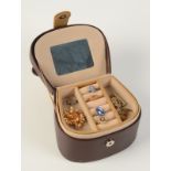 An opal ring and other jewellery in a leather box.