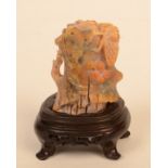 A Chinese soapstone carving of a cicada on a tree trunk, wooden stand, total height 10cm.