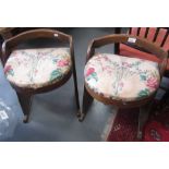 A pair of Arts and Crafts oak chairs, each with a padded seat, height 51cm, width 40cm, depth 37.