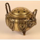 A Chinese polished bronze censer, with a pair of handles and three stile feet, height 9cm,