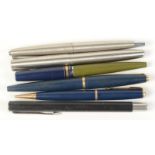 Five Parker fountain pens and a Parker propelling pencil.