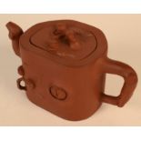 A Chinese Yixing teapot, decorated with fruit and branches, impressed seal mark to base and cover,