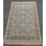 A Kashan rug, the green ground with four rows of two linked floral medallions,