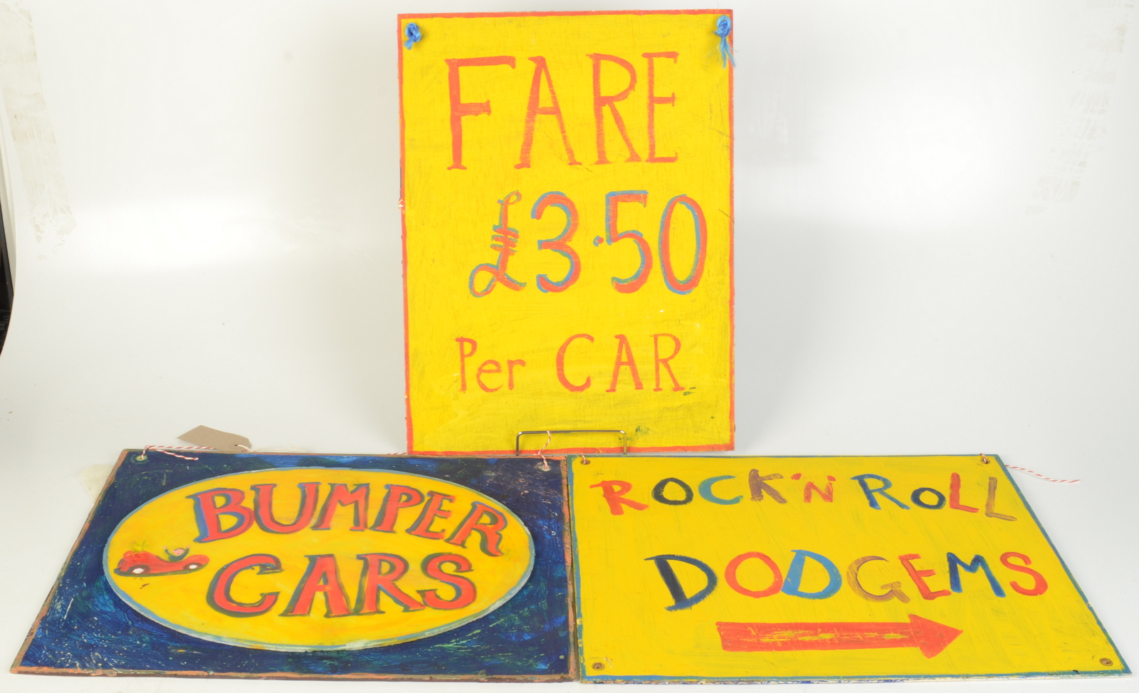 Bumper Cars, a painted sign, together with two other painted signs.