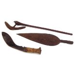 A tribal axe, length 72.5cm, a Nepalese kukri, length 42cm and an African spearhead, length 48.5cm.