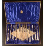 A set of six pistol grip dessert knives and forks with filled silver handles and silver blades,