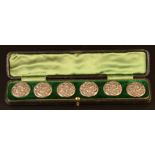 A set of six flower and acanthus cast silver buttons, Birmingham 1902, cased.