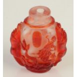 A clear and red glass carved overlay snuff bottle, with lion phoenix and dragon, height 6.6cm.